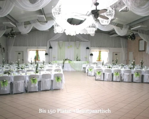 Zentral ausgerichtete Tischordnung mit Sicht auf Bühne und Brauttisch – 154 Personen in der Halle Partyland